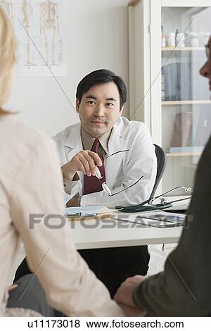 Doctor listening to patients View Large Photo Image Stock Photo - Doctor listening to patients. Fotosearch