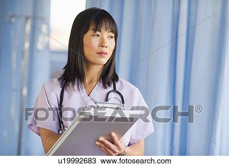 Doctor noting in medical chart of clipboard View Large Photo Image Stock Image - Doctor noting in medical chart of clipboard. Fotosearch