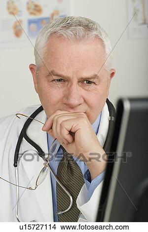 Picture - Doctor working on computer. Fotosearch
