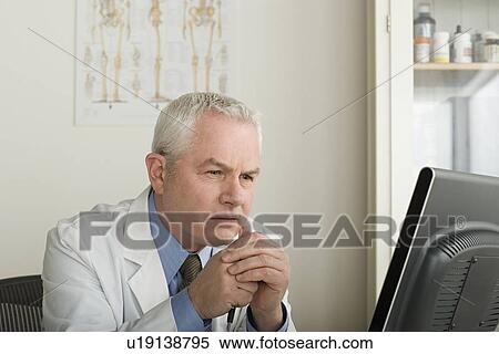 Doctor working on computer View Large Photo Image Stock Photography - Doctor working on computer. Fotosearch