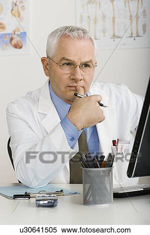 Stock Photography - Doctor working on computer. Fotosearch