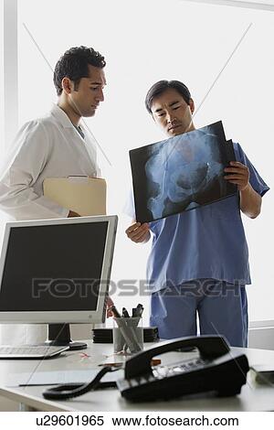 Doctors looking at x-ray image View Large Photo Image Stock Photography - Doctors looking at x-ray image. Fotosearch