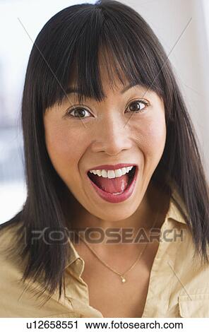 Stock Image - Excited mid adult woman. Fotosearch