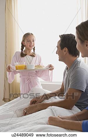 Family breakfast in bed View Large Photo Image Stock Photo - Family breakfast in bed. Fotosearch