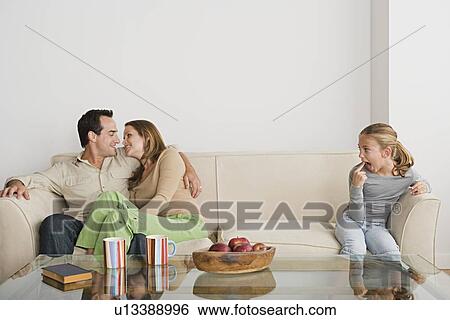Stock Photograph - Family in living-room. Fotosearch