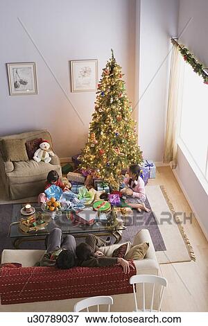 Family with two daughters (10-11) at Christmas morning View Large Photo Image Stock Photo - Family with two daughters (10-11) at Christmas morning. Fotosearch