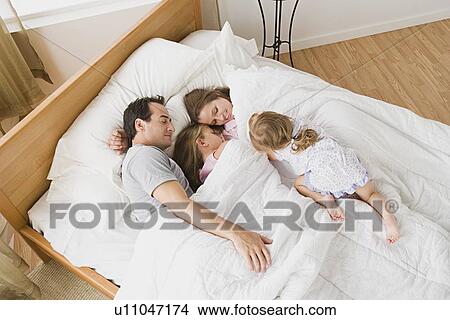 Family with two daughters (8-9, 12-13) in bed View Large Photo Image Picture - Family with two daughters (8-9, 12-13) in bed. Fotosearch