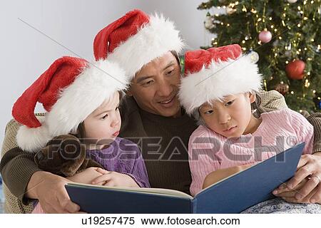 Father reading to two daughters (10-11) View Large Photo Image Stock Photography - Father reading to two daughters (10-11). Fotosearch