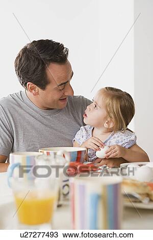 Father with daughter having breakfast View Large Photo Image Stock Image - Father with daughter having breakfast. Fotosearch