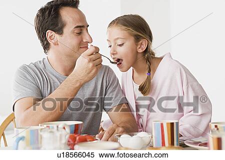 Father with daughter having breakfast View Large Photo Image Stock Photography - Father with daughter having breakfast. Fotosearch