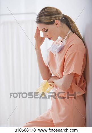 Female doctor leaning to wall View Large Photo Image Stock Photo - Female doctor leaning to wall. Fotosearch