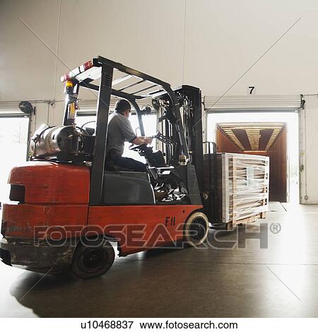 Forklift driver working in warehouse View Large Photo Image Stock Photo - Forklift driver working in warehouse. Fotosearch