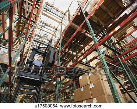 Forklift truck stacking boxes in warehouse View Large Photo Image Picture - Forklift truck stacking boxes in warehouse. Fotosearch