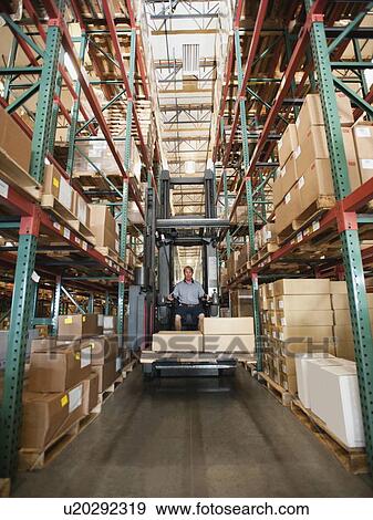 Forklift truck stacking boxes in warehouse View Large Photo Image Stock Photo - Forklift truck stacking boxes in warehouse. Fotosearch
