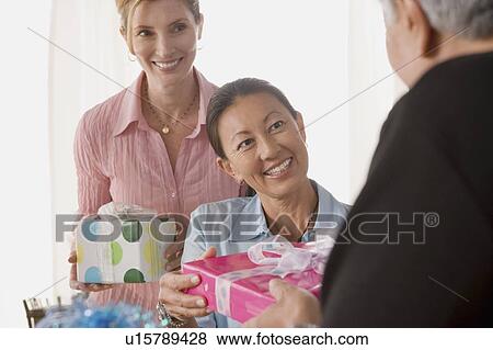 Stock Photo - Friends celebrating mature women's birthday. Fotosearch