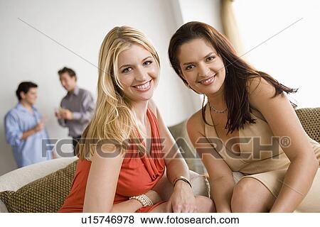 Stock Photo - Friends having party at home. Fotosearch