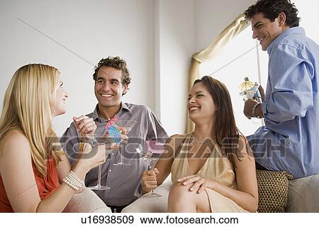 Stock Photo - Friends having party at home. Fotosearch
