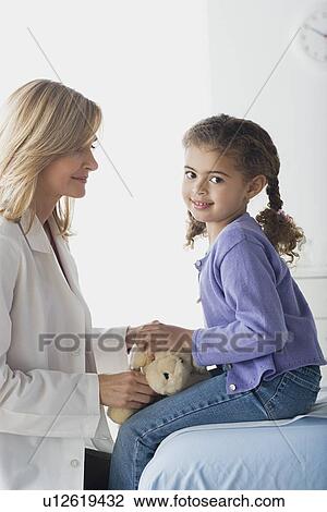 Stock Image - Girl (10-11) and doctor. Fotosearch