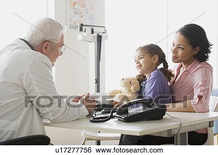 Girl (10-11) with mother talking to doctor View Large Photo Image Stock Photograph - Girl (10-11) with mother talking to doctor. Fotosearch