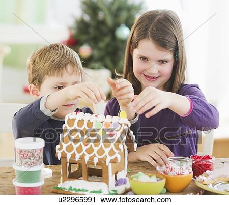 Girl (8-9) and boy (6-7) preparing gingerbread decorations View Large Photo Image Stock Image - Girl (8-9) and boy (6-7) preparing gingerbread decorations. Fotosearch