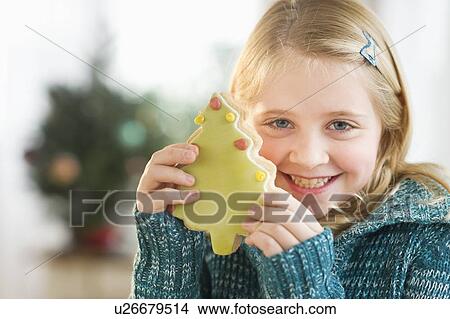 Girl (8--9) holding gingerbread cookie View Large Photo Image Picture - Girl (8--9) holding gingerbread cookie. Fotosearch