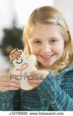 Girl (8--9) holding gingerbread cookie View Large Photo Image Stock Photography - Girl (8--9) holding gingerbread cookie. Fotosearch