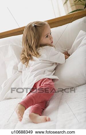 Girl (8-9) lying in bed View Large Photo Image Stock Photo - Girl (8-9) lying in bed. Fotosearch