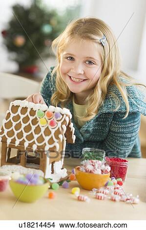 Girl (8--9) making gingerbread house View Large Photo Image Picture - Girl (8--9) making gingerbread house. Fotosearch