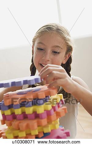 Girl setting jigsaw View Large Photo Image Stock Image - Girl setting jigsaw. Fotosearch