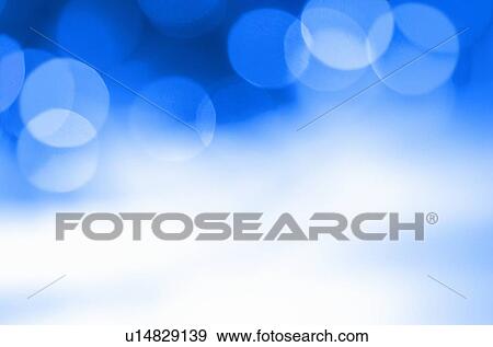 Stock Photo - Glowing light on blue background, studio shot. Fotosearch