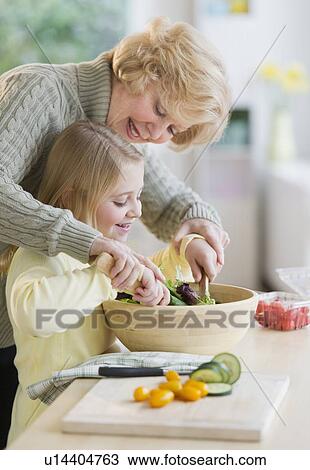 Grandmother and granddaughter (8-9) preparing salad together View Large Photo Image Stock Image - Grandmother and granddaughter (8-9) preparing salad together. Fotosearch