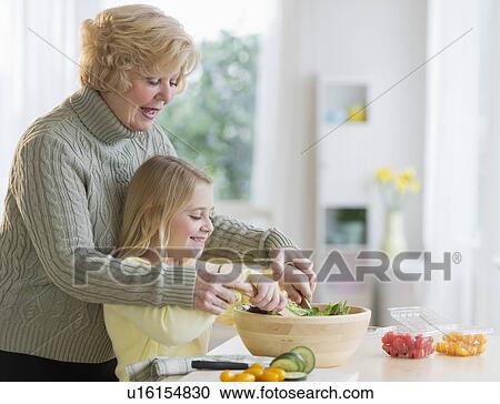 Grandmother and granddaughter (8-9) preparing salad together View Large Photo Image Stock Image - Grandmother and granddaughter (8-9) preparing salad together. Fotosearch