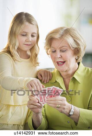 Grandmother with granddaughter (8-9) playing cards View Large Photo Image Stock Image - Grandmother with granddaughter (8-9) playing cards. Fotosearch