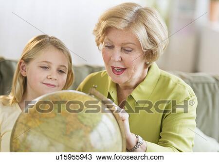 Grandmother with granddaughter (8-9) looking at globe View Large Photo Image Stock Image - Grandmother with granddaughter (8-9) looking at globe. Fotosearch