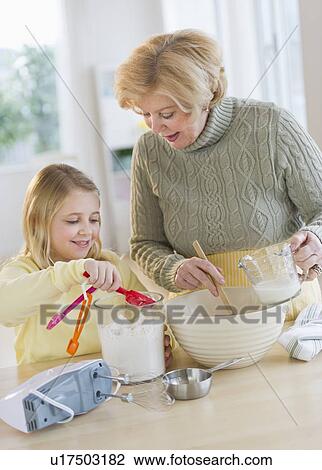 Grandmother with granddaughter (8-9) preparing food View Large Photo Image Stock Image - Grandmother with granddaughter (8-9) preparing food. Fotosearch