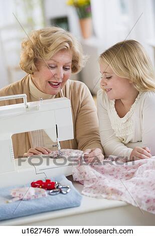 Grandmother with granddaughter (8-9) sewing together View Large Photo Image Stock Photo - Grandmother with granddaughter (8-9) sewing together. Fotosearch