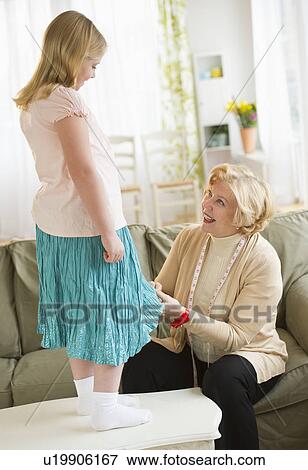 Grandmother with granddaughter (8-9) sewing together View Large Photo Image Stock Photo - Grandmother with granddaughter (8-9) sewing together. Fotosearch