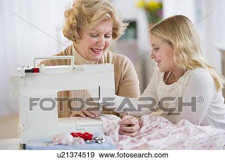 Grandmother with granddaughter (8-9) sewing together View Large Photo Image Stock Photo - Grandmother with granddaughter (8-9) sewing together. Fotosearch