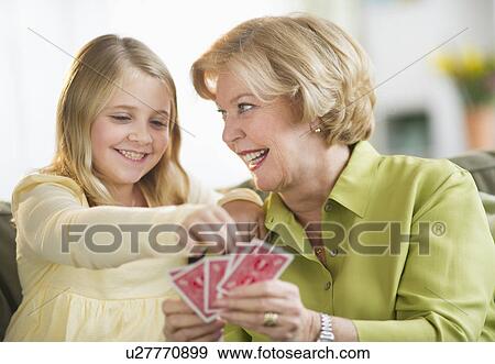 Grandmother with granddaughter (8-9) playing cards View Large Photo Image Stock Photo - Grandmother with granddaughter (8-9) playing cards. Fotosearch