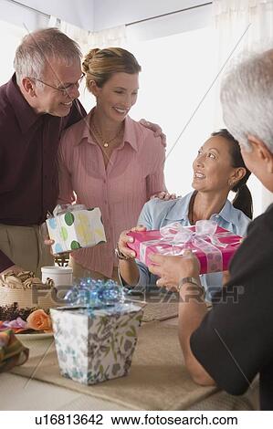 Stock Image - Group of friends at birthday party. Fotosearch