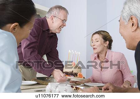 Stock Photo - Group of friends at birthday party. Fotosearch