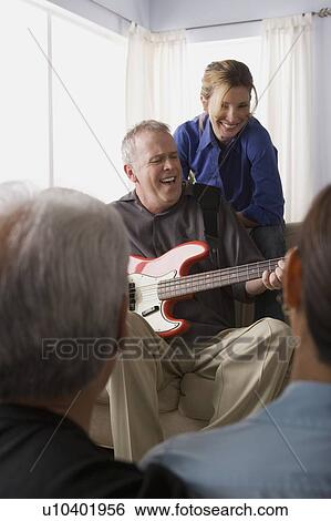 Stock Photograph - Group of friends having fun with guitar. Fotosearch