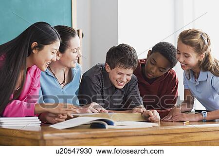 Group of school children having fun while reading book View Large Photo Image Stock Image - Group of school children having fun while reading book. Fotosearch