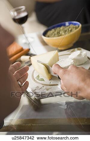 Hand cutting cheese View Large Photo Image Stock Image - Hand cutting cheese. Fotosearch