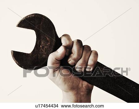Hand holding wrench, studio shot View Large Photo Image Picture - Hand holding wrench, studio shot. Fotosearch