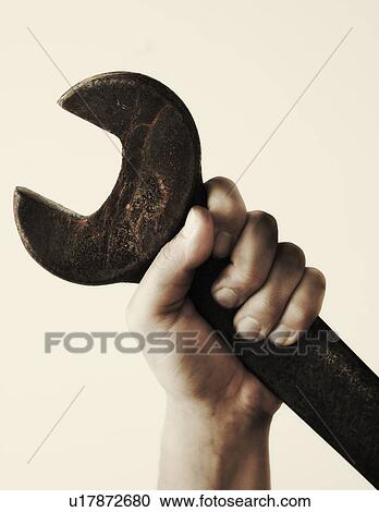 Hand holding wrench, studio shot View Large Photo Image Stock Image - Hand holding wrench, studio shot. Fotosearch