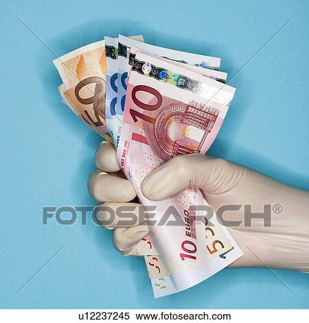 Hand in surgical glove holding banknotes View Large Photo Image Stock Photography - Hand in surgical glove holding banknotes. Fotosearch
