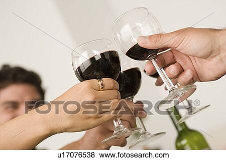Hands holding wineglasses during toast View Large Photo Image Stock Photo - Hands holding wineglasses during toast . Fotosearch