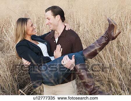 Happy young couple on wheat field View Large Photo Image Stock Photography - Happy young couple on wheat field. Fotosearch