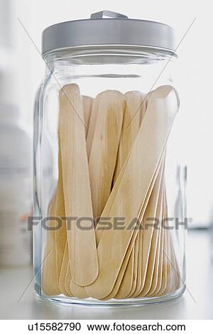 Stock Image - Jar with tongue depressors . Fotosearch